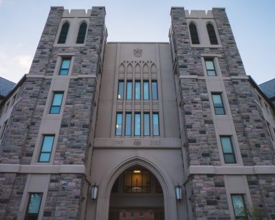 Grey Hokie Stone Upper Quad Hall North residence hall on a clear morning